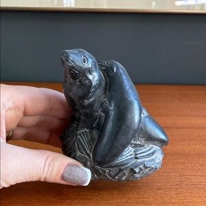 Wolf Original" sculpture, depicting two seals on a rock base.